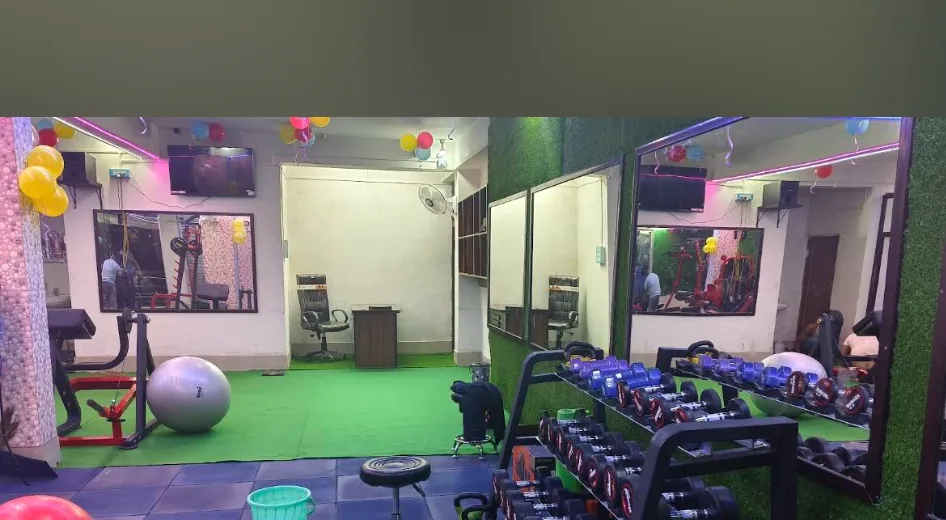 Dumbbell free-weights rack, wall mirrors, and training floor at B.M. Fitness Studio