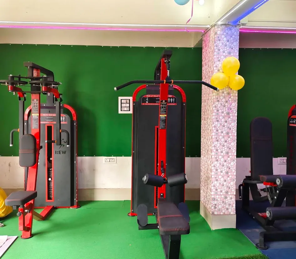 Pec fly, lat pulldown, and leg resistance machines at B.M. Fitness Studio