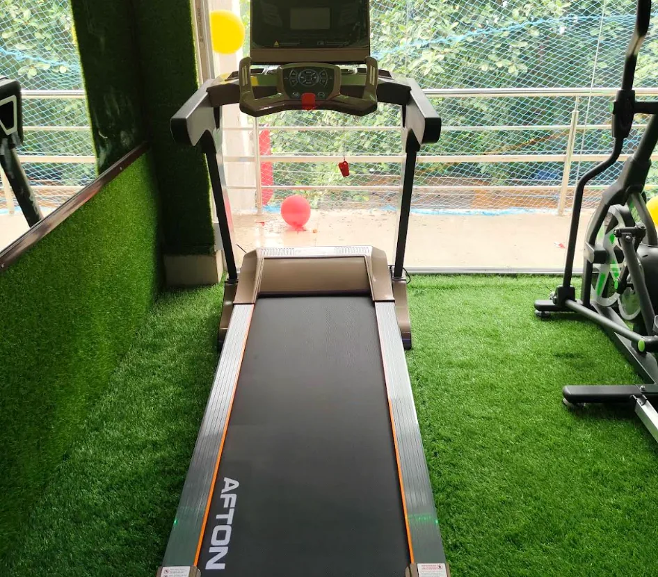 AFTON motorized treadmill on artificial turf overlooking the studio window